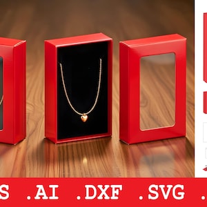 May include: Three red jewelry boxes with clear windows, showcasing a gold necklace with a heart pendant. One box is open, revealing a black interior. The boxes are on a wooden surface.