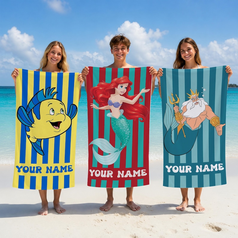 May include: Three beach towels with cartoon characters. One has a yellow and blue striped background with a cartoon fish. Another has a red and teal striped background with a mermaid. The third has a blue and teal striped background with a cartoon character with a trident. Each towel has the text "YOUR NAME".