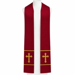 May include: A deep red liturgical stole featuring two vertical panels that drape over the shoulders. Each panel is decorated with a gold embroidered cross centered between two horizontal gold bands near the bottom edge of the garment.