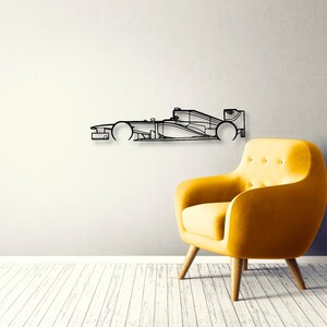 May include: A black metal wall art piece shaped like the side profile of a Formula One race car. The design features a minimalist outline of the vehicle's chassis, including the front nose, cockpit area, side pods, and rear wing structure.