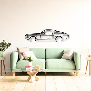May include: A black metal wall art piece shaped like the side profile of a classic fastback car. The design features clean, minimalist lines outlining the body, roofline, hood, and trunk of the vehicle, creating a sleek silhouette for display.