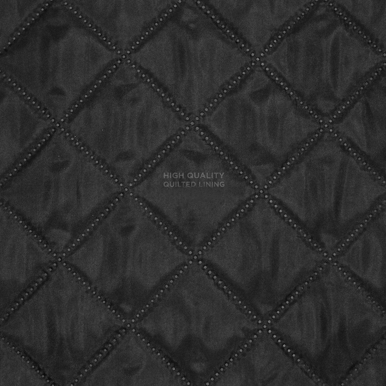 A black fabric material featuring a quilted diamond pattern with stitched lines. The centre of the image displays the text HIGH QUALITY QUILTED LINING in a light grey font, indicating the texture and construction of the textile surface.