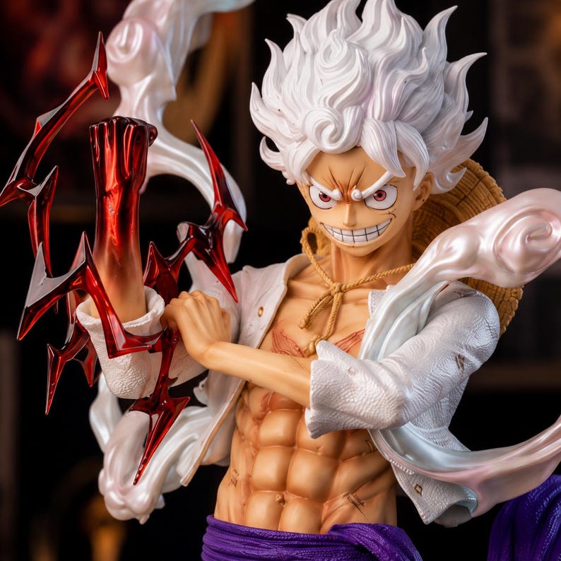 May include: A detailed figurine of a character with spiky white hair, a straw hat, and a determined expression. The figure is wearing a white jacket, purple sash, and has a muscular physique. Red and white energy effects emanate from the figure's arm.