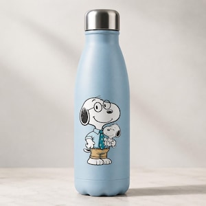 May include: A light blue reusable water bottle with a metallic silver cap. The front features a graphic of a white cartoon dog wearing round glasses, a light blue shirt with a patterned tie, and tan trousers, while holding a smaller white puppy.