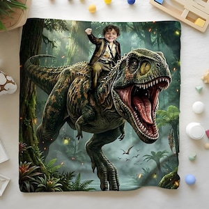 May include: A digitally created blanket featuring a child riding a Tyrannosaurus Rex through a lush, prehistoric jungle. The dinosaur is detailed with green and brown scales, and the child is wearing a brown jacket. The background includes trees and flying birds.