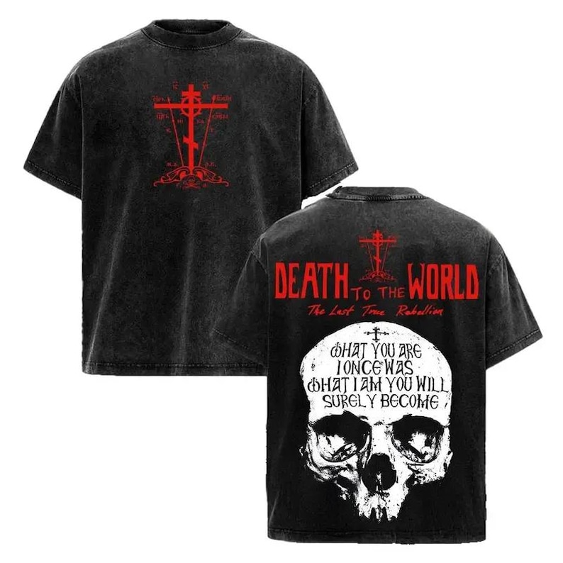 May include: A black acid-wash t-shirt featuring a red cross graphic on the front. The back displays the red text "DEATH TO THE WORLD" and "The Last True Rebellion" above a large white skull with the text "WHAT YOU ARE I ONCE WAS WHAT I AM YOU WILL SURELY BECOME."