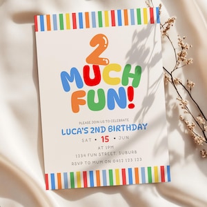 May include: A rectangular birthday invitation card featuring a colorful striped border at the top and bottom. The text reads 2 MUCH FUN! in large, multi-colored bubble letters, followed by details for Luca's 2nd birthday on Saturday, June 15th at 1pm.