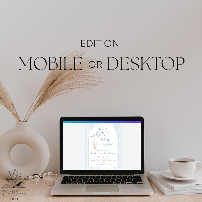May include: A laptop screen displays a digital birthday invitation template featuring a goose illustration and the text Noah is one silly goose. The text EDIT ON MOBILE OR DESKTOP is centered above the laptop. A white vase and coffee cup are present.
