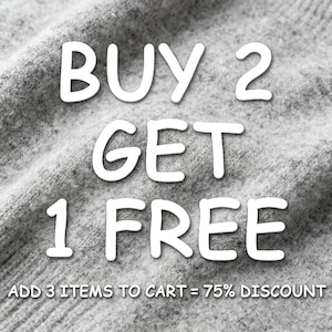 May include: White text on a grey fabric background reads "BUY 2 GET 1 FREE". Beneath, smaller text states "ADD 3 ITEMS TO CART = 75% DISCOUNT". The fabric has a textured appearance.
