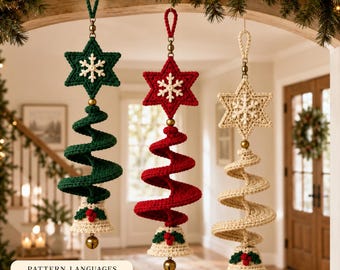 May include: Three hanging crochet ornaments featuring a star at the top, a spiral tree body, and a bell at the bottom. The ornaments are in dark green, red, and cream, each accented with a white snowflake, green leaves, and red berries.