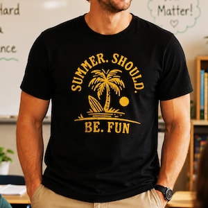 May include: Black t-shirt with a yellow graphic of a palm tree, surfboard, and sun, with the text "SUMMER. SHOULD. BE. FUN." The shirt is a crew neck and appears to be made of cotton.
