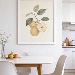 May include: A framed botanical wall art print featuring a watercolor illustration of three yellow pears and green leaves on a cream background. The artwork is displayed in a simple white frame, showcasing a detailed depiction of the fruit.