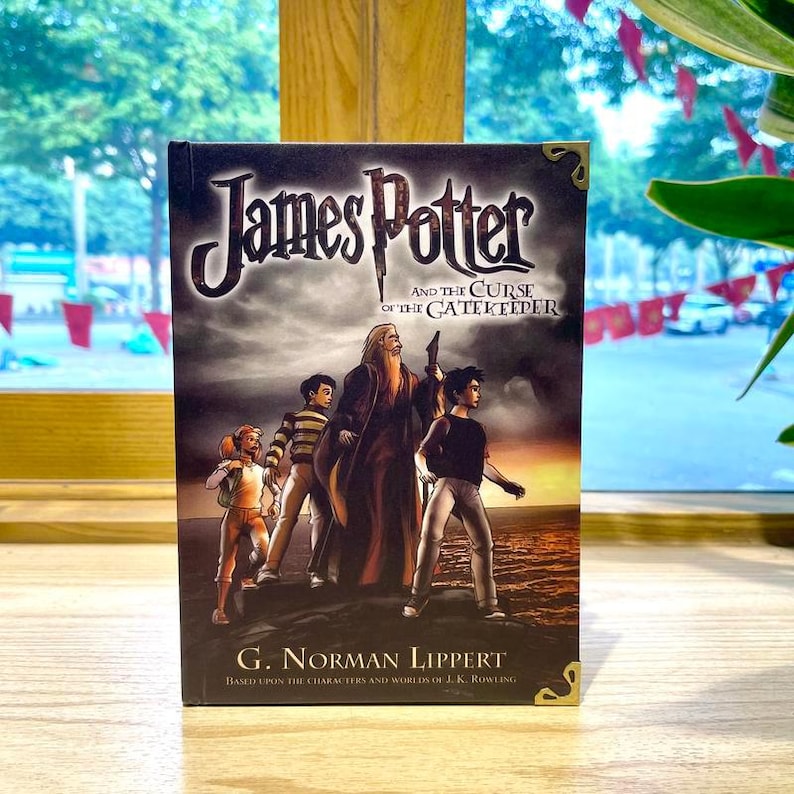 May include: A hardcover book titled James Potter and the Curse of the Gatekeeper by G. Norman Lippert. The cover features an illustration of four characters standing on a dark landscape against a sunset sky, with gold-toned corner accents.