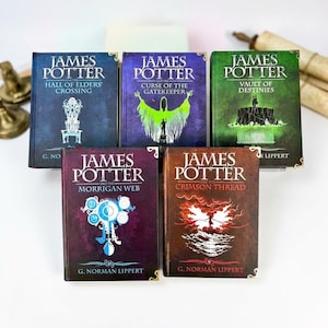 May include: A collection of five James Potter books by G. Norman Lippert, including Hall of Elders' Crossing, Curse of the Gatekeeper, Vault of Destinies, Morrigan Web, and Crimson Thread, featuring distinct cover art in blue, purple, green, and red.