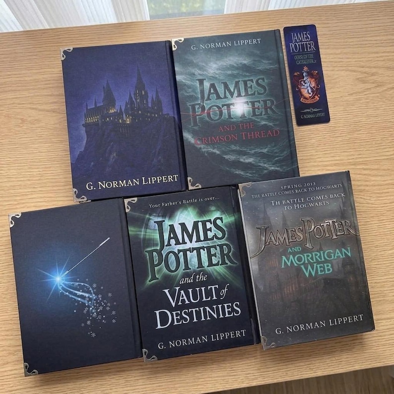 May include: A collection of four hardcover books by G. Norman Lippert titled James Potter and the Crimson Thread, The Vault of Destinies, and Morrigan Web, alongside a dark blue vertical bookmark featuring a crest and the text James Potter.