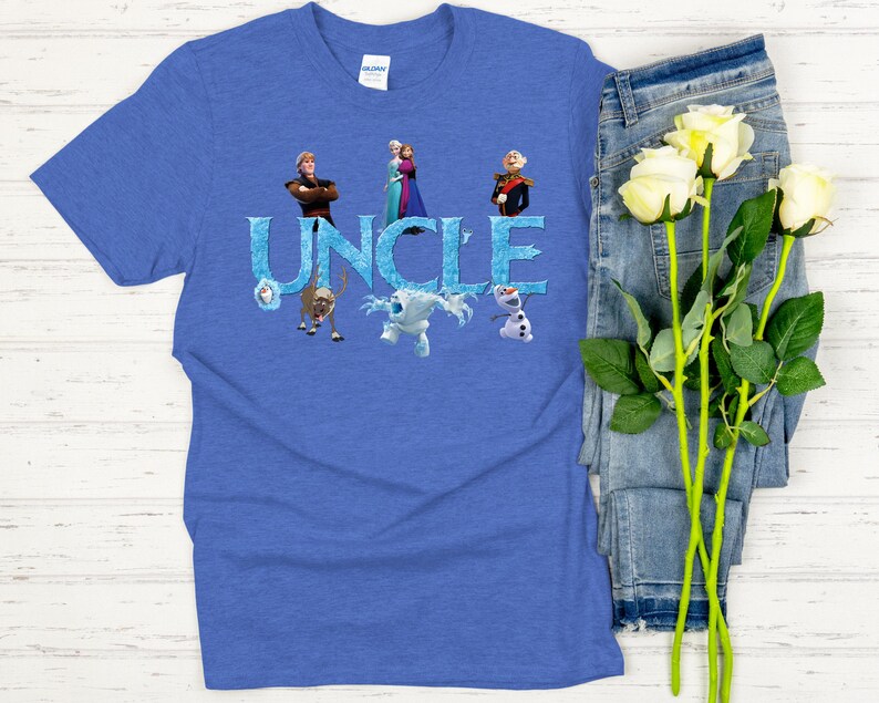 May include: Blue t-shirt with the word "UNCLE" in icy blue letters, featuring characters from the movie Frozen. The shirt has a crew neck and short sleeves. The design includes images of Anna, Elsa, Kristoff, Olaf, and Sven.