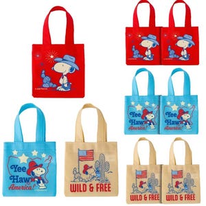 May include: A collection of small tote bags in red, blue, and tan. Each bag features a cartoon Snoopy character in cowboy attire. Some bags have the text "Yee Haw America!" or "Wild & Free".