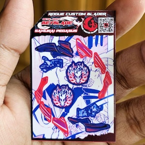 May include: A rectangular sticker sheet featuring Rogue Custom Blader Metal Fight Beyblade Samurai Pegasus branding. The design includes red and blue graphic elements, two circular Pegasus emblems, and a QR code on a white background with text.