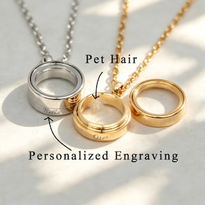 May include: Three pendant necklaces: one silver, two gold. The gold pendant in the center contains pet hair and is engraved with "Oreo." The silver pendant is engraved with "Bella." The text "Pet Hair" and "Personalized Engraving" are also visible.