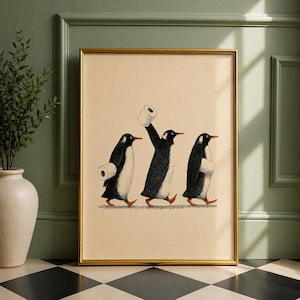May include: A framed wall art print featuring three black and white penguins walking in a line against a light beige background. Each penguin is carrying a white roll of toilet paper, with the centre penguin holding one roll high above its head.