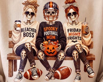 May include: A beige crewneck sweatshirt featuring a graphic of three skeletons sitting on a bench. The skeletons wear sweaters with the text BLEACHER BOSS, SPOOKY FOOTBALL MOM, and FRIDAY NIGHT FRIGHTS. They hold coffee cups and a pumpkin bucket.