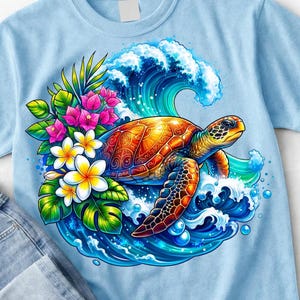 May include: A light blue t-shirt featuring a vibrant graphic of a sea turtle swimming through a large blue ocean wave, surrounded by colorful tropical flowers including pink bougainvillea and white plumeria blossoms with green leaves.