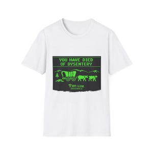 May include: White t-shirt with a green graphic that reads "YOU HAVE DIED OF DYSENTERY." The graphic depicts a covered wagon, oxen, and mountains. The text "OFF-LINE ORIGINALS" is below the graphic.