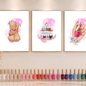 May include: Three framed art prints featuring nail art themes. One print shows hands and feet with pink nail polish, another displays a tiered tray of nail polish bottles, and the third shows a hand holding a pink nail polish bottle.