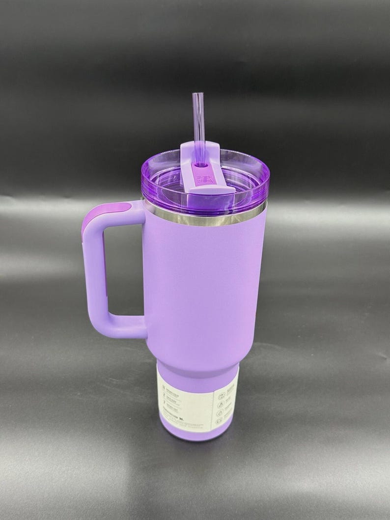 Peut inclure: Un gobelet isotherme lavande avec une poign&eacute;e et un couvercle transparent. Le gobelet a un bord en acier inoxydable et une poign&eacute;e lavande assortie. Une paille transparente est ins&eacute;r&eacute;e dans le couvercle. Id&eacute;al pour les boissons chaudes ou froides.