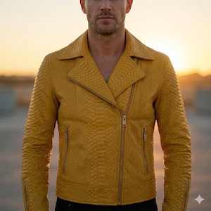 May include: Mustard yellow leather jacket with a textured snakeskin pattern. The jacket features a notched collar, an asymmetrical zipper closure, and zippered pockets. The jacket is worn over a black shirt.