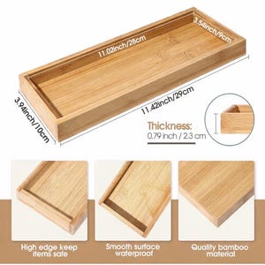 May include: A rectangular bamboo tray with a natural wood grain finish. The tray measures 11.42 inches by 3.94 inches with a thickness of 0.79 inches. The interior dimensions are 11.02 inches by 3.54 inches. It features high edges and a smooth surface.