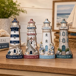 May include: Four decorative lighthouse figurines with illuminated lanterns. Each features unique nautical details like anchors, ropes, shells, and flowers. The base of each lighthouse is inscribed with the text, From Amelia With Love - Est. 2026.