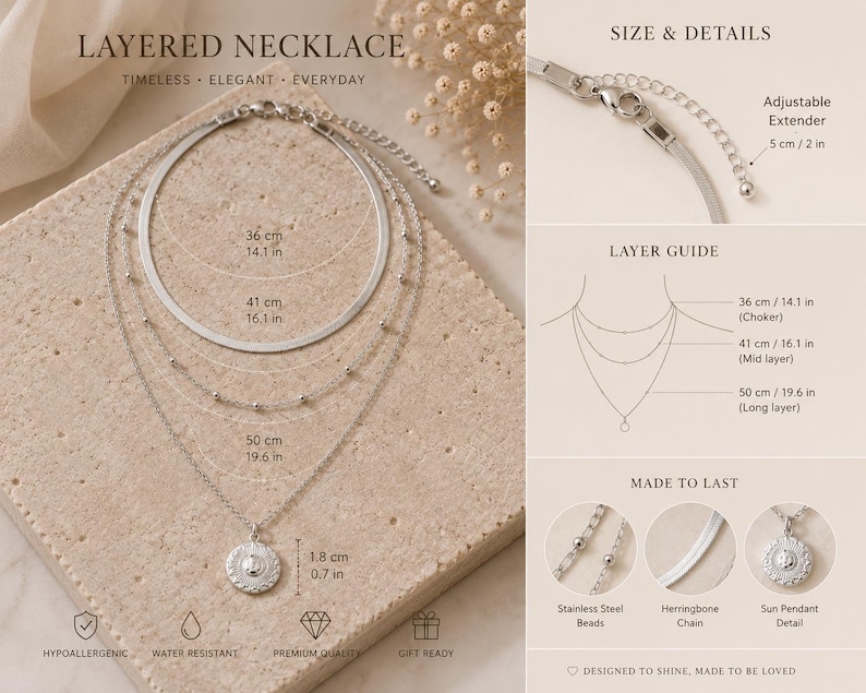 Op de afbeelding: Een zilverkleurige gelaagde ketting met een visgraatketting, een kralenketting en een zonhanger. De set bevat een verstelbare verlengketting van 5 cm. De lengtes zijn 36 cm, 41 cm en 50 cm, met een hanger van 1,8 cm in diameter.