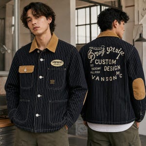 May include: A dark navy blue pinstriped jacket with a tan corduroy collar, tan elbow patches, and tan pocket flaps. The front features a Vanson Leathers patch. The back displays white text reading Drag Strip Custom Design Vanson MC.