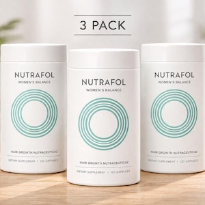 May include: Three white cylindrical bottles of Nutrafol Women's Balance hair growth supplement. Each bottle has a teal concentric circle design and the text "NUTRAFOL WOMEN'S BALANCE". The text "HAIR GROWTH NUTRACEUTICAL" and "DIETARY SUPPLEMENT • 120 CAPSULES" are also visible.