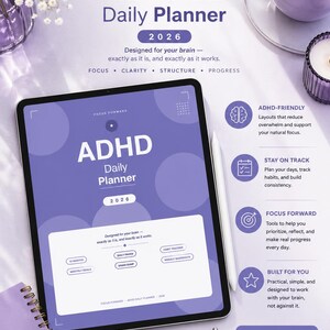 May include: Purple ADHD Daily Planner 2026 with text: "Designed for your brain - exactly as it is, and exactly as it works." Includes a tablet, notebook, pen, and coffee cup. The planner has sections for daily pages, monthly goals, and weekly snapshots.