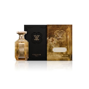May include: A glass perfume bottle with a gold-toned liquid and a faceted design, accompanied by a black box and a gold-toned box featuring a classical illustration. Both boxes display the text Velixir and a logo with the letters VV.