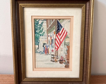 Lámina artística vintage en acuarela con escena de una tienda general de un pequeño pueblo con una gran bandera estadounidense.