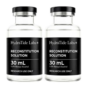 May include: Two clear glass bottles with black caps and silver rims. Each bottle has a black label with white text that reads "HydraTide Labs* RECONSTITUTION SOLUTION 30 mL 0.9% Benzyl Alcohol RESEARCH USE ONLY."