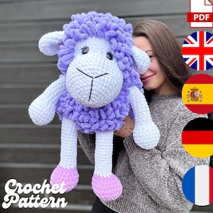 May include: A large, handmade crochet sheep plushie in white and lavender. The sheep has a fluffy, textured body, white limbs, and pink hooves. The text "Crochet Pattern" is visible in the lower left corner.