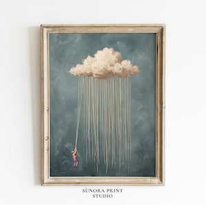 May include: A framed wall art print featuring a small figure in a red shirt and dark trousers hanging from a single long string attached to a large, textured beige cloud against a dark teal background. The text SUNORA PRINT STUDIO is below.