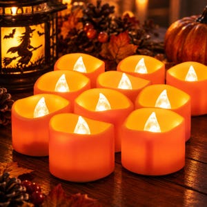 May include: A set of ten orange LED tea light candles with a wavy top edge and a white flame-shaped bulb. Each candle emits a warm, glowing light, creating a soft illumination. The candles are arranged in a group, featuring a smooth, solid orange exterior finish.