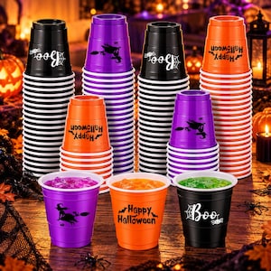 May include: A collection of plastic party cups in black, purple, and orange, stacked in multiple columns. The cups feature black printed graphics including a witch on a broomstick, the text Happy Halloween, and the word Boo with a spider web.