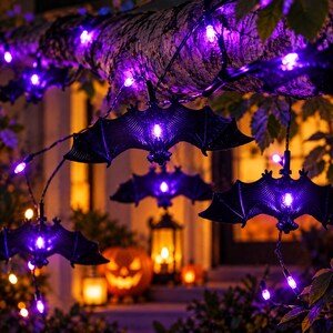 May include: A string of decorative lights featuring black bat-shaped covers that glow with a vibrant purple light. The bat figures are connected by a dark wire, with each bat housing a small, bright purple bulb at its center, creating a festive display.
