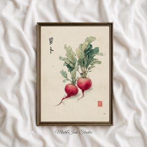 May include: A framed wall art print featuring a watercolour illustration of two red radishes with green leafy tops on a cream-coloured background. The artwork includes black Japanese calligraphy characters on the left and a small red square seal stamp.