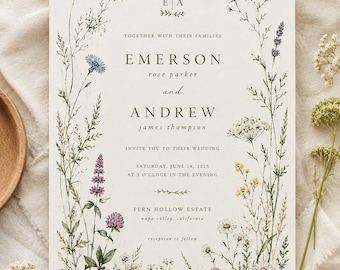May include: A rectangular wedding invitation card featuring a white background with a botanical border of watercolour wildflowers in yellow, blue, purple, and white. The text includes the names Emerson Rose Parker and Andrew James Thompson.