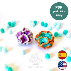 May include: Two crocheted coral-like structures, one in purple and white and the other in orange and teal, surrounded by small light blue pom-poms. A circular green badge reads PDF pattern only, and a logo features a cactus with the text Crochet Con Lillo.