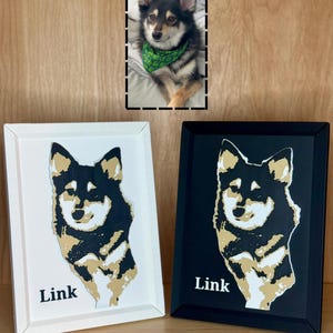 May include: Two framed portraits of a dog with black, tan, and white fur. One frame is white and the other is black. Both portraits feature a stylised illustration of the dog and the name Link printed in white or black text at the bottom left.