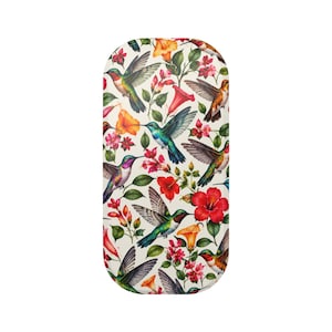 May include: An oval-shaped hard case featuring a vibrant botanical pattern on a cream background. The design displays multiple hummingbirds in shades of green, blue, and orange, interspersed with bright red, orange, and pink tropical flowers.