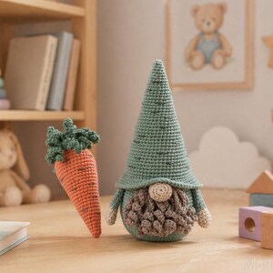 May include: A crocheted gnome with a green hat and beard, and an orange carrot with green leaves. The gnome has a round body and a long, pointed hat. The carrot is standing upright next to the gnome. The items are on a wooden surface.